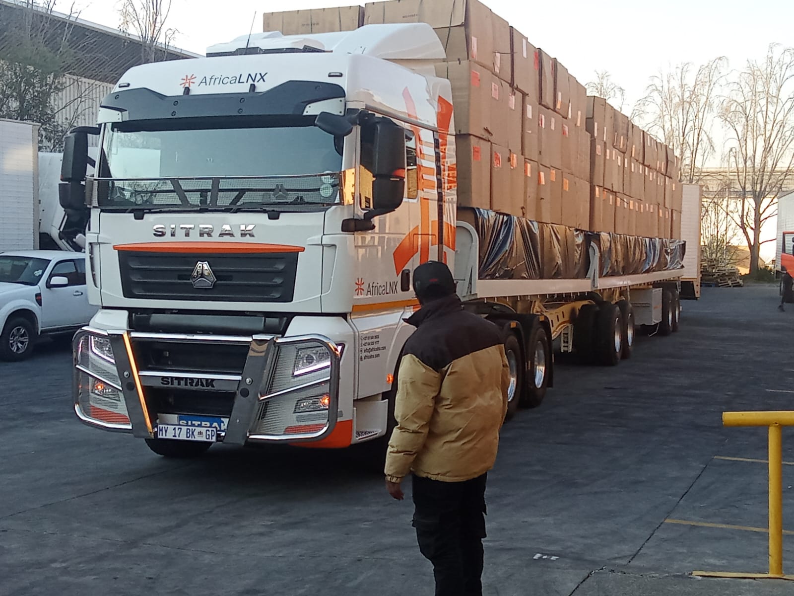 AfricaLNX flatbed truck carrying a covered load