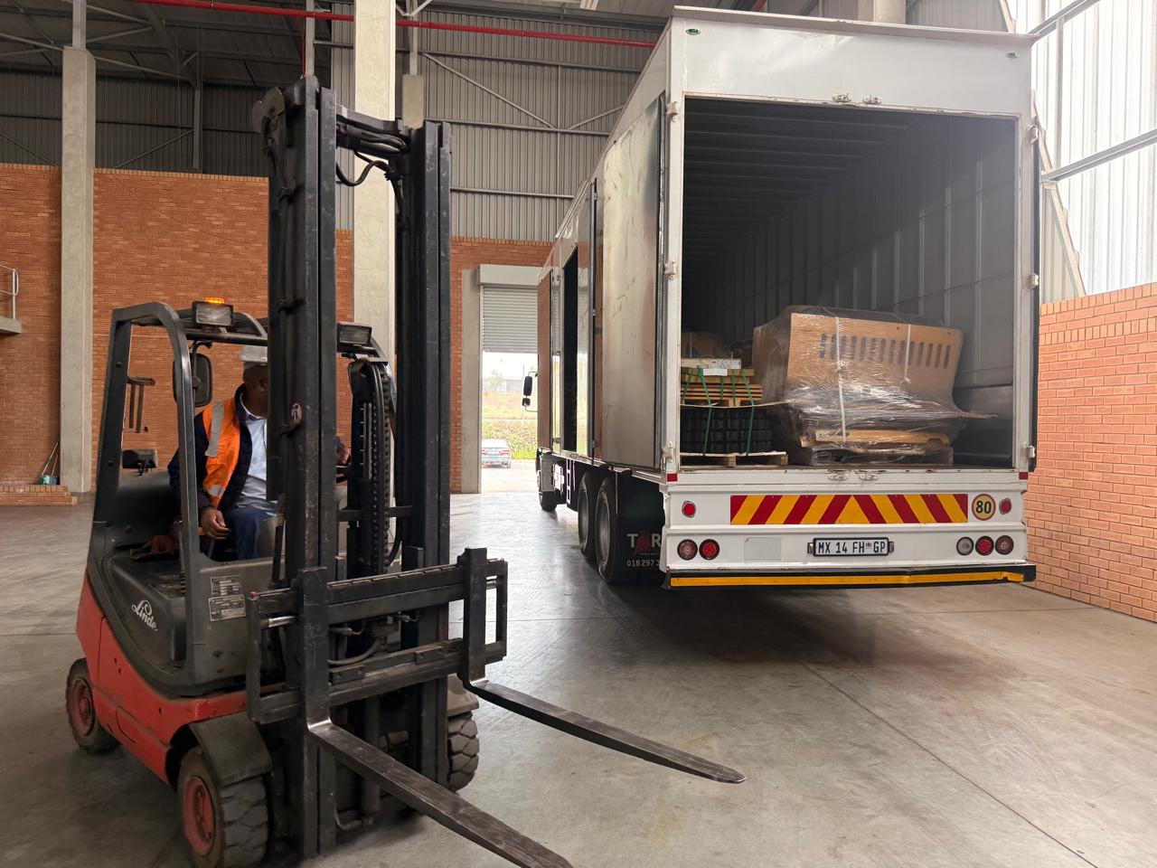 Forklift beside an AfricaLNX truck during loading